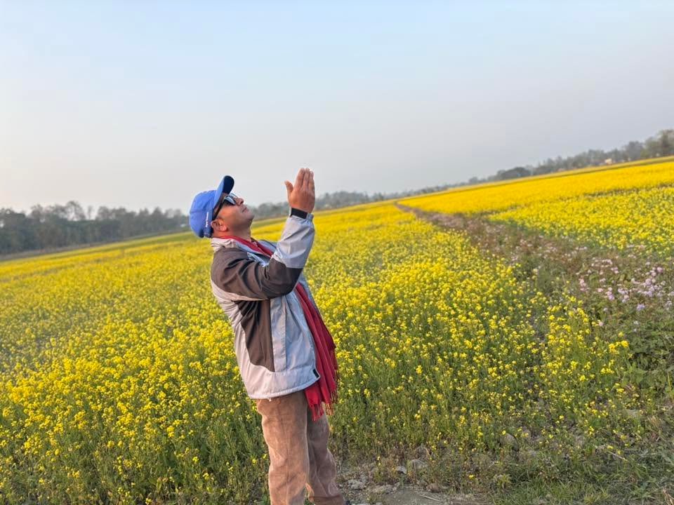 Pritam standing in a mustard field